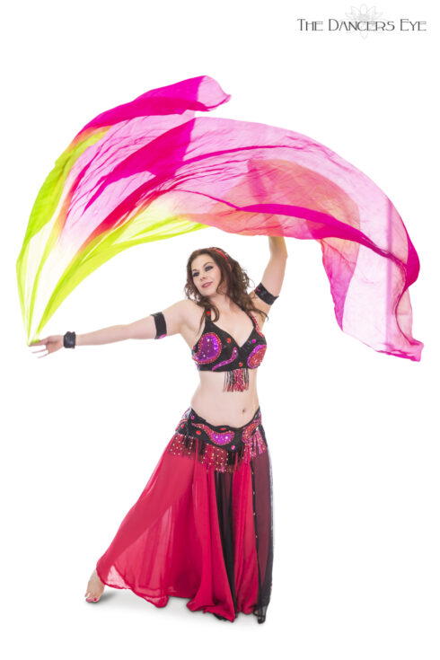 Image of a belly dancer wearing a red top and flowing red skirt with a pink scarf flowing above her head, on a white background