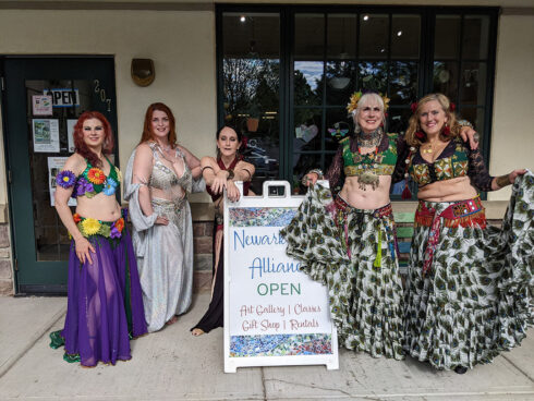 Image of 5 belly dancers in beautiful outfits outside the Newark Arts Alliance