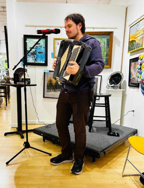 Image showing a musician playing an accordian during open mic night