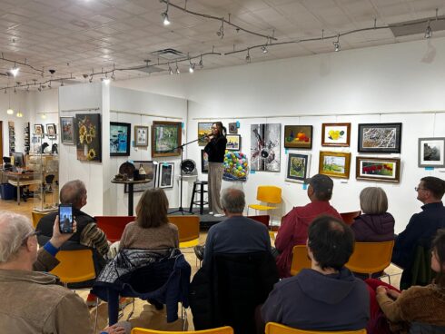 Image showing an artist performing during an open mic night in the gallery