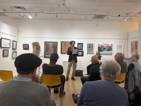 Image showing an artist performing during an open mic night in the gallery