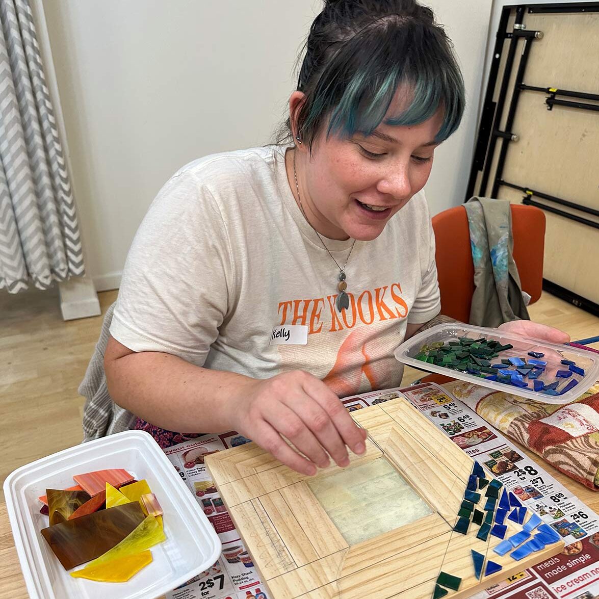A student working on her mosaic picture frame